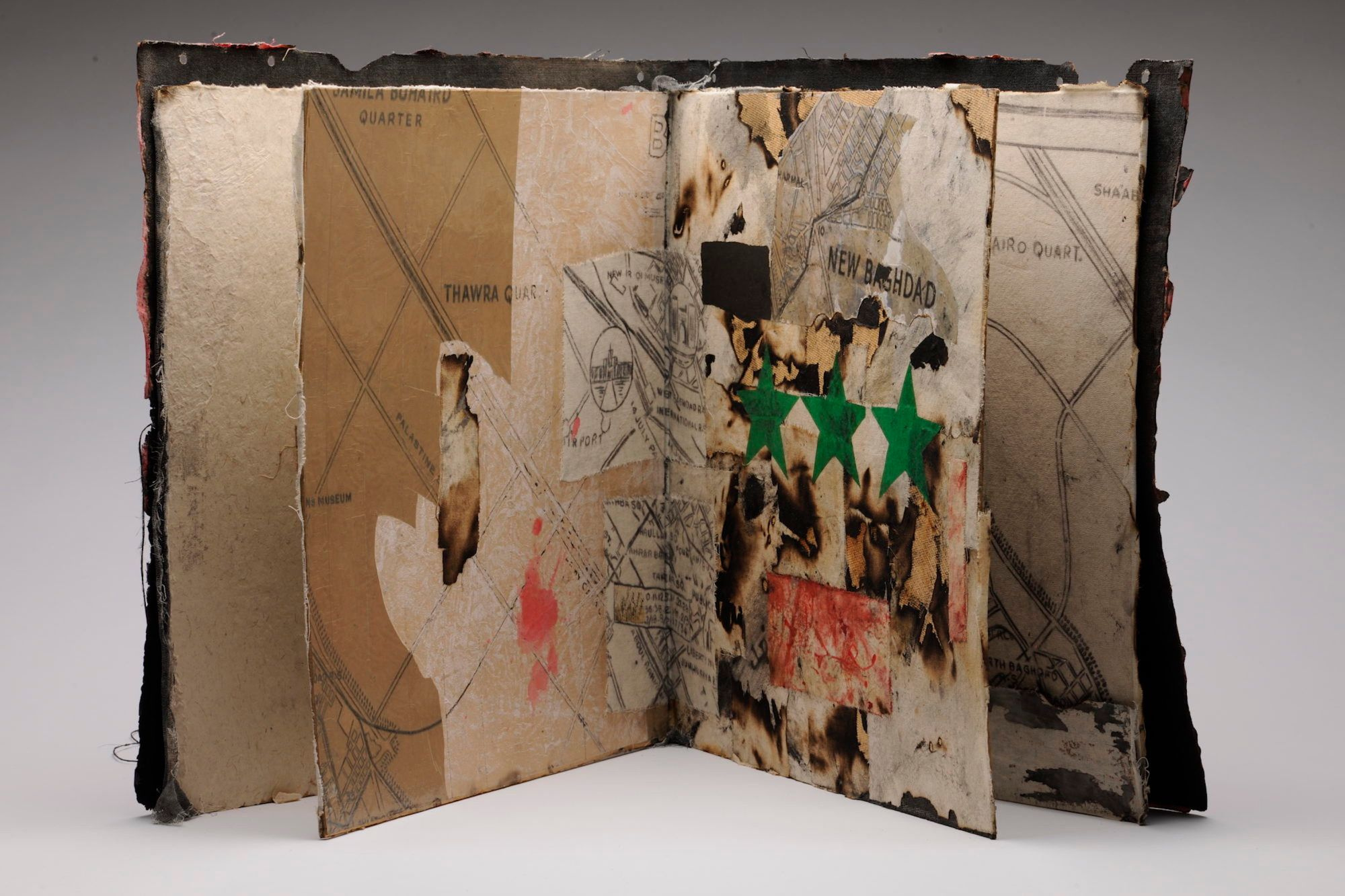 Hanaa Malallah, Baghdad City: US Map, 2007. Ink, collage, burning, and tape on wood, 53 × 55 cm. Courtesy of the artist and Azzawi Collection, London. Photo by Anthony Dawton.