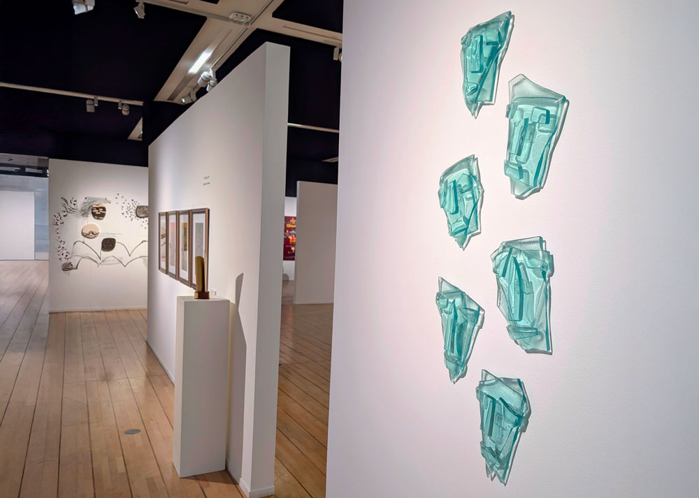 Faces, six abstract glass faces formed from layered fragments of thick glass, 2026